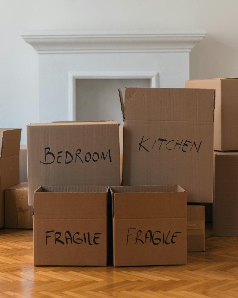 Stacked Moving Boxes Labeled for Different Rooms